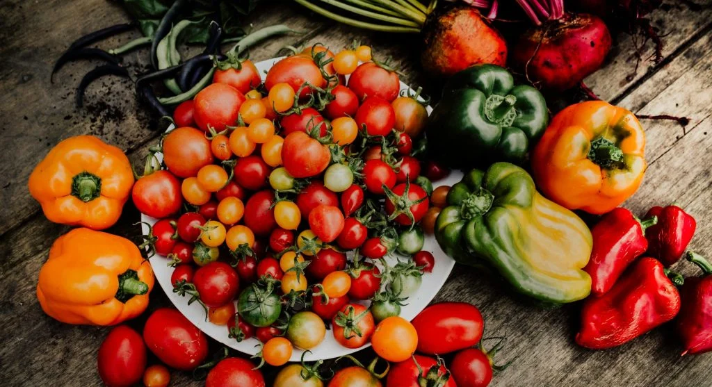 Close-up of fresh organic peppers and tomatoes showcasing vibrant colors and healthy produce.