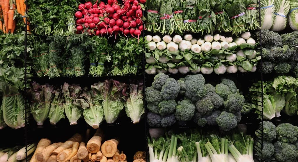 Floating row cover draped over broccoli or cabbage plants on wire hoops