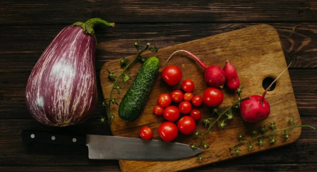 Variety of fast-growing vegetables arranged on a cutting board beans, greens, radishes